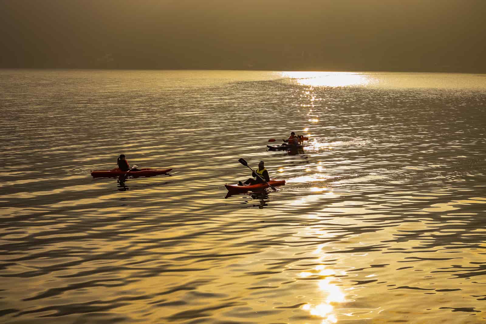 A kayak on still water in low evening light