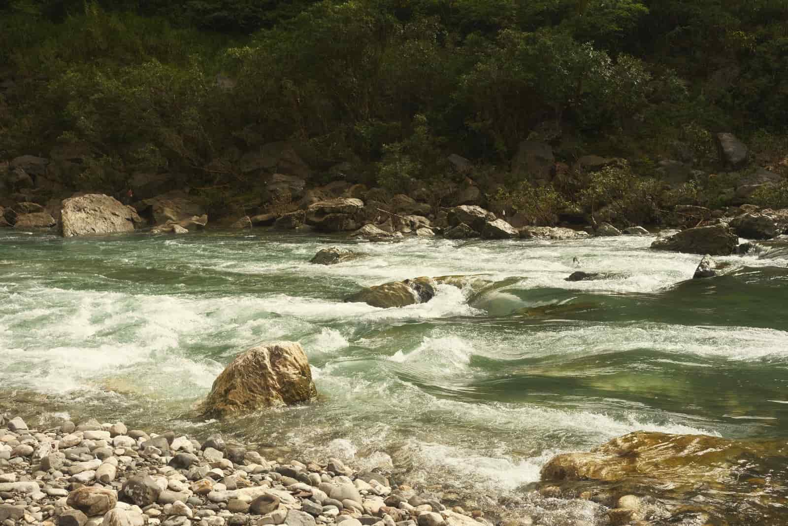 A calm river running between forested banks