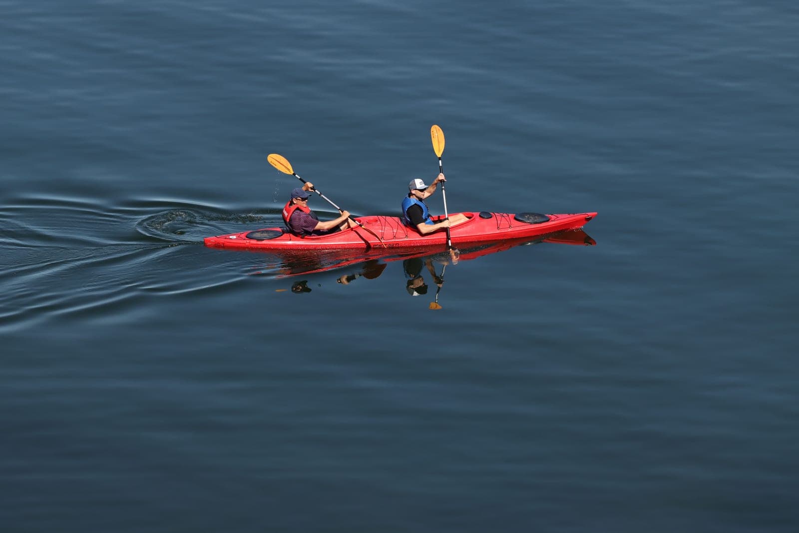 A tandem kayak seen from above on calm water