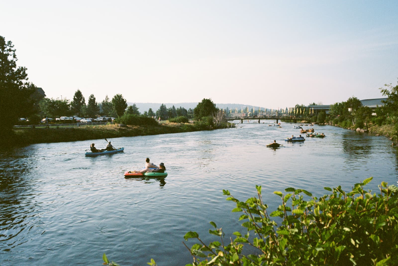 An inflatable tandem kayak pulled up on a quiet shoreline