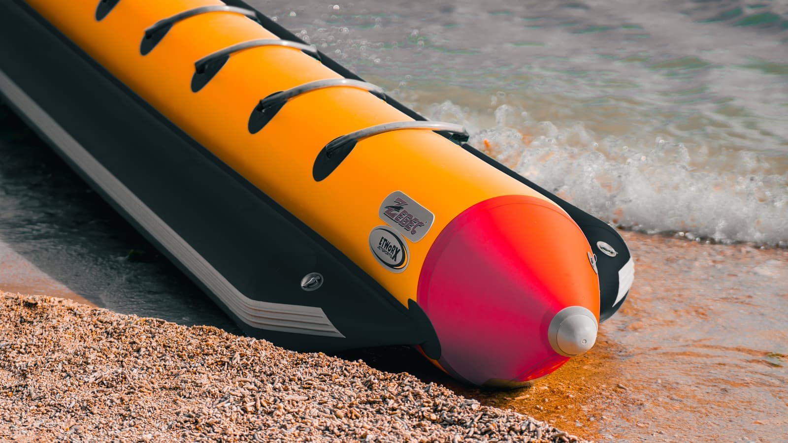 The tube and seam detail of an inflatable craft on a shoreline