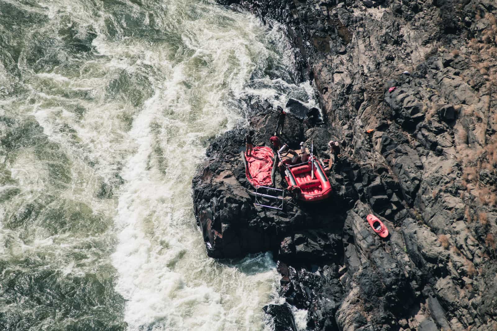 Paddling gear and dry bags loaded on a rocky bank