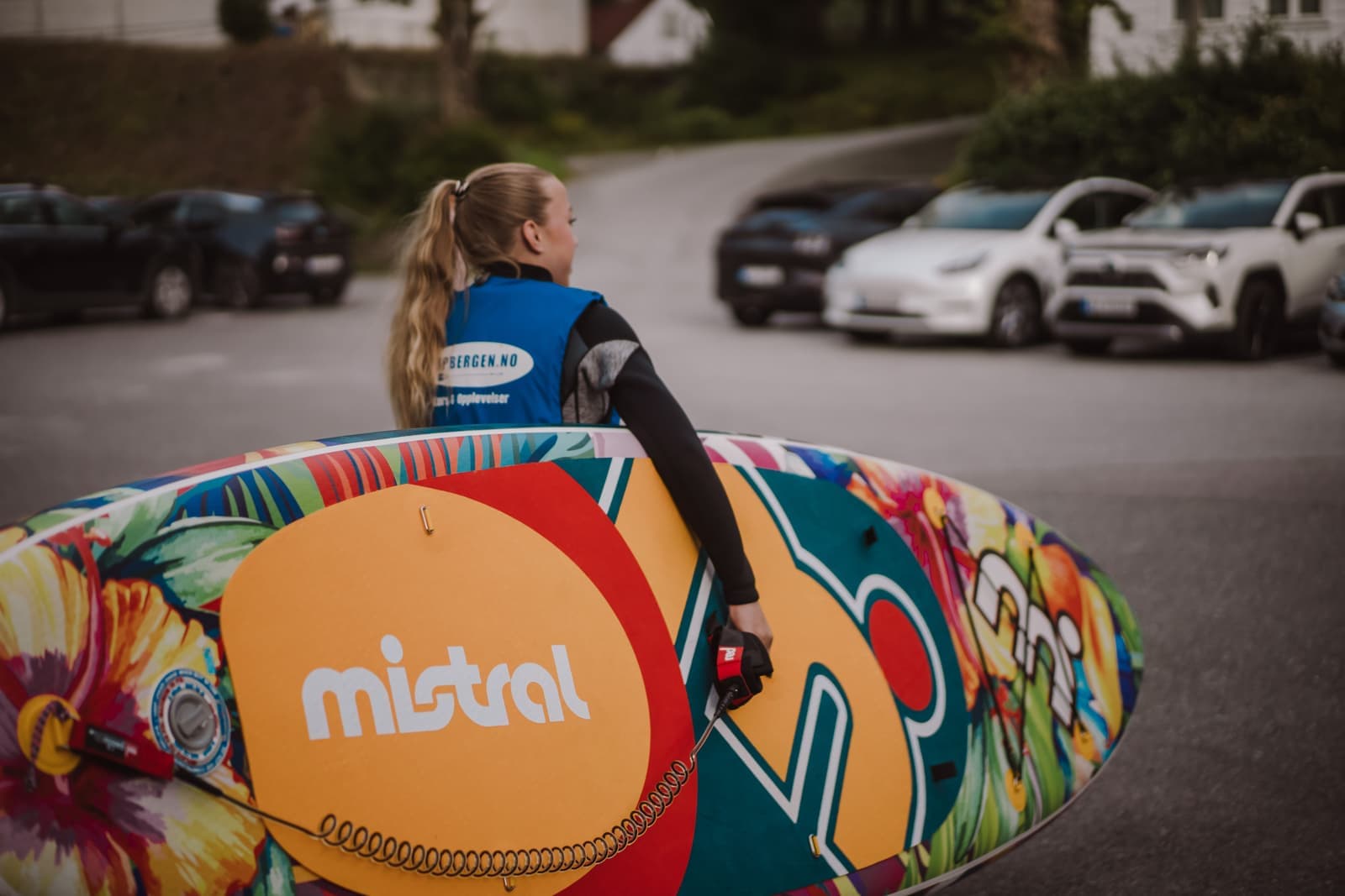 A paddle board being carried to the water