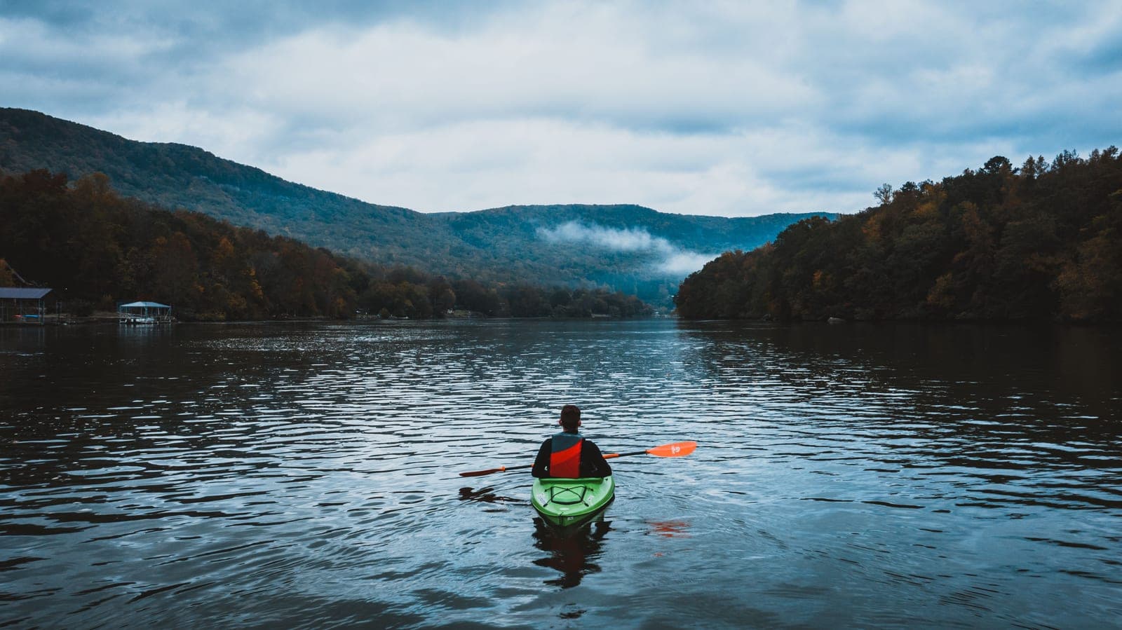 A single paddler on flat water early in the morning