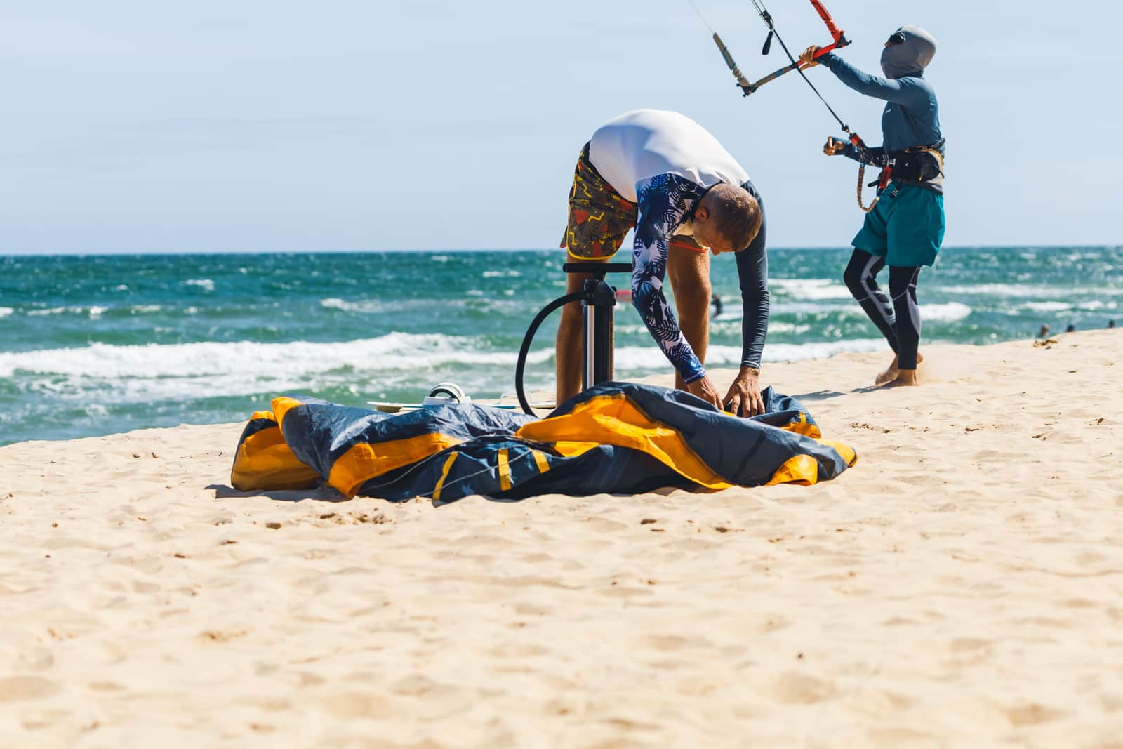 A pump and paddling gear on a beach