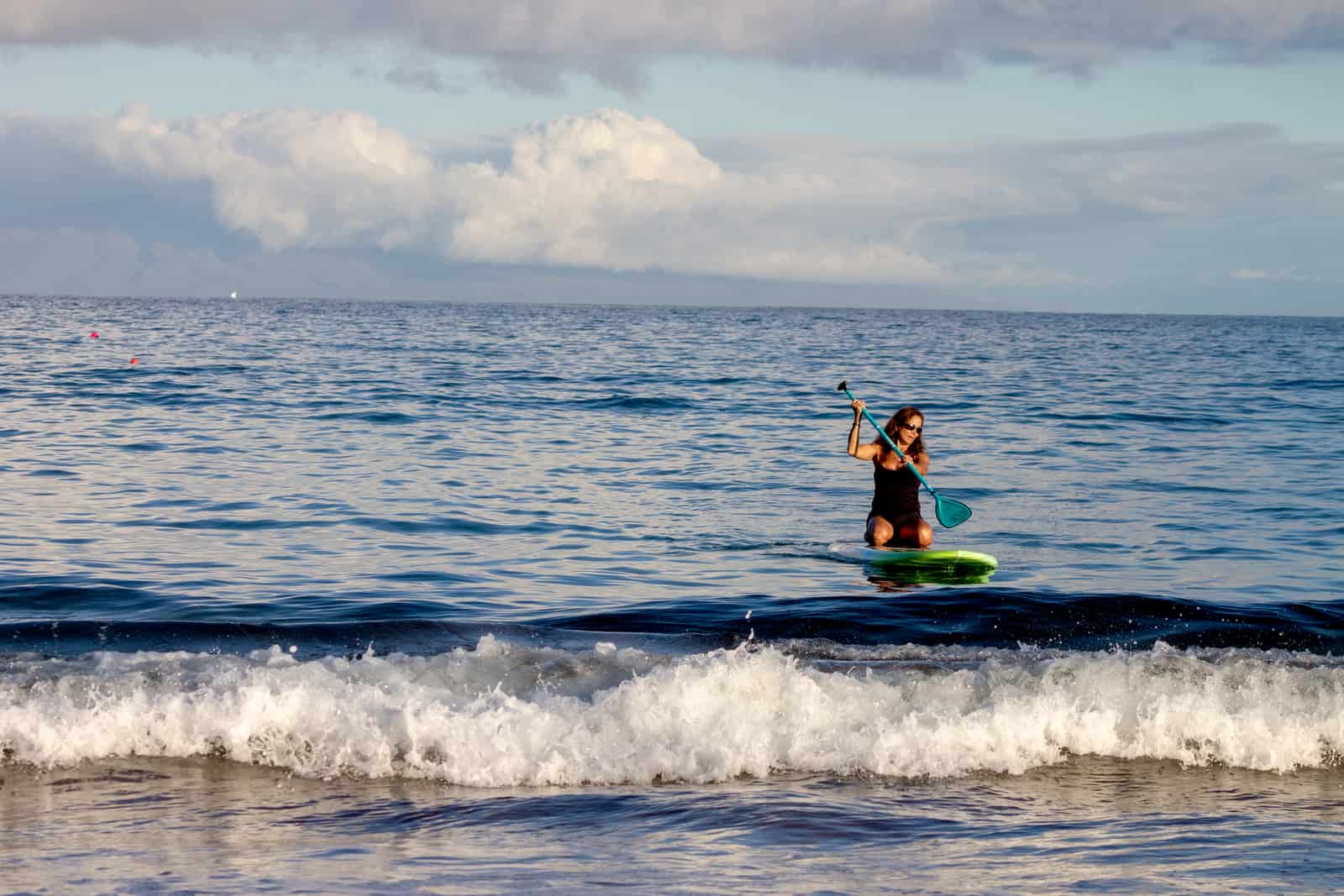 A paddler on a board on flat water
