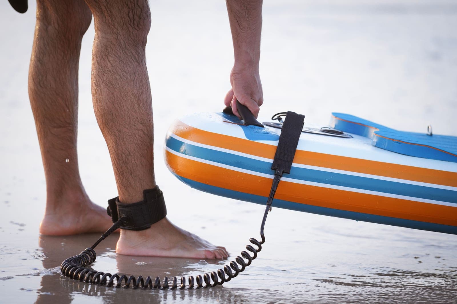A pump and paddling gear set down at the water's edge